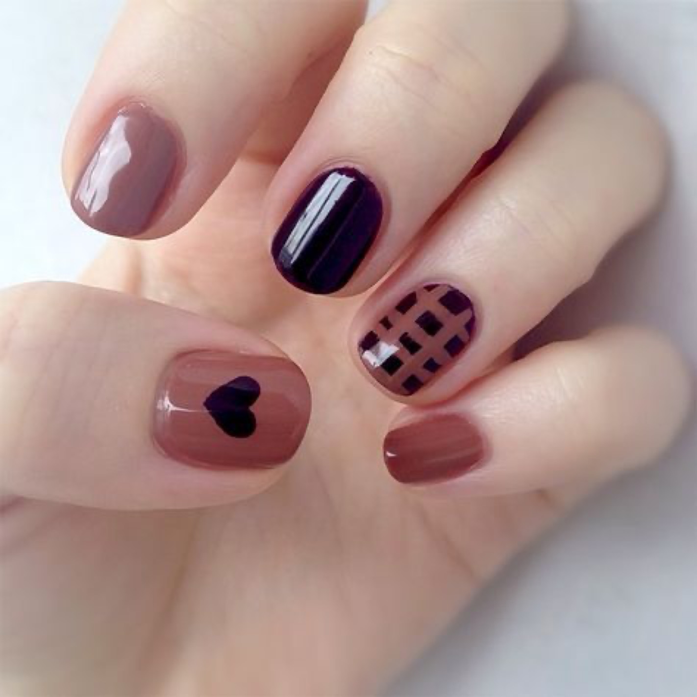 Burgundy and black nail designs with heart motif