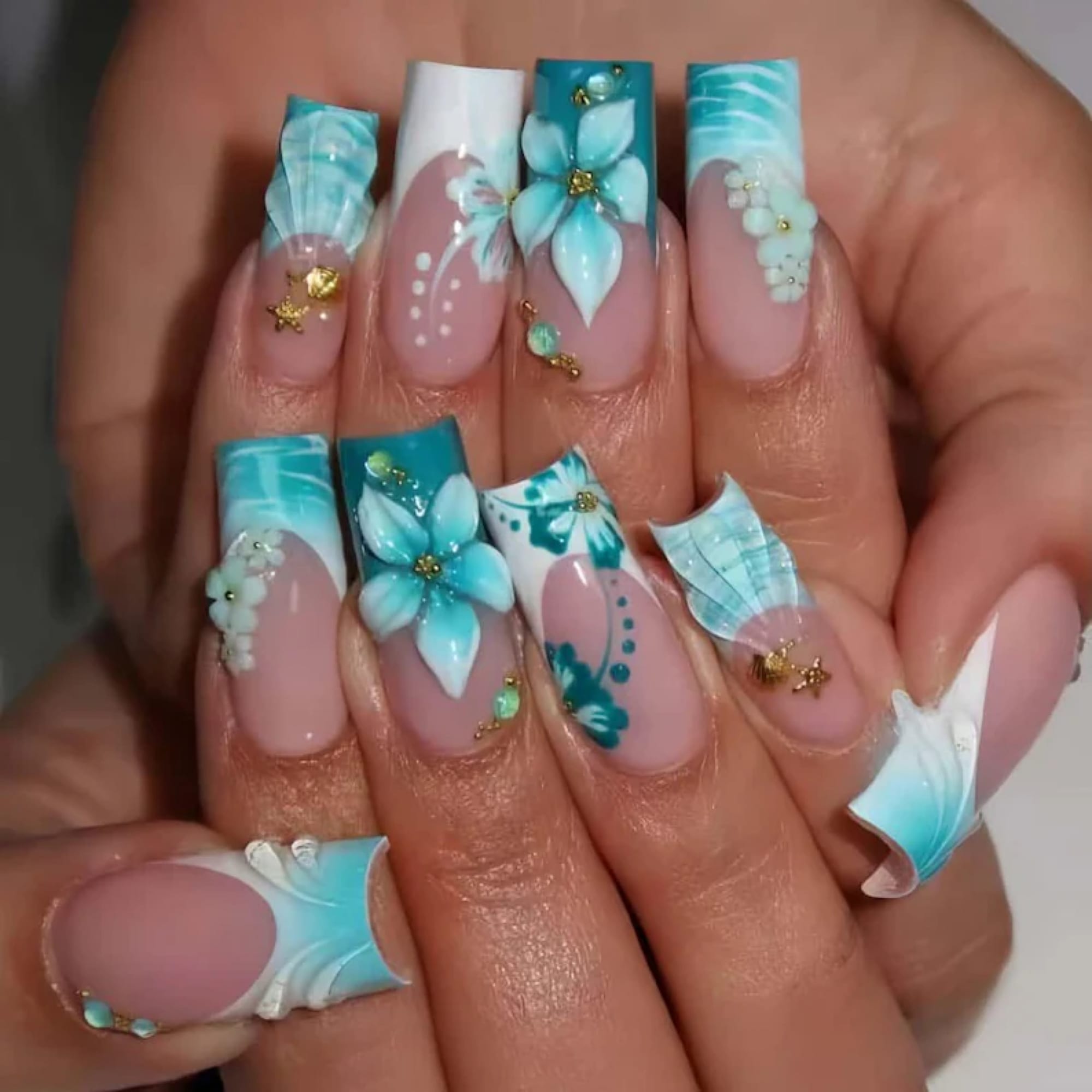 Turquoise floral nail art with gold accents
